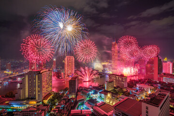Fantastic Multicolor Firework exploding over the Bangkok Cityscape river side for Celebration,...