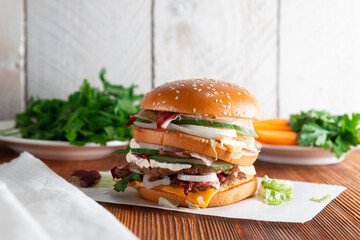 Fast food Burger. Close-up of tasty burger on a dark wooden table and the background of a brick wall. Different type of sandwiches