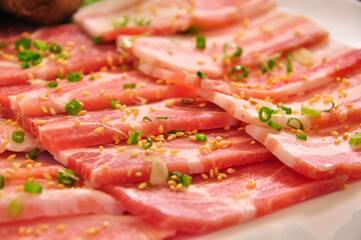 Close of set of raw and slicing Japanese pork with sesame and spicy