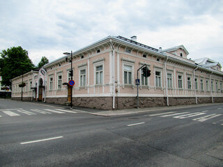 Old pink wooden house on crossroads.