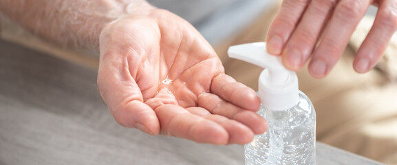 Hand pressing on sanitizer bottle; prevention of virus and bacteria infection