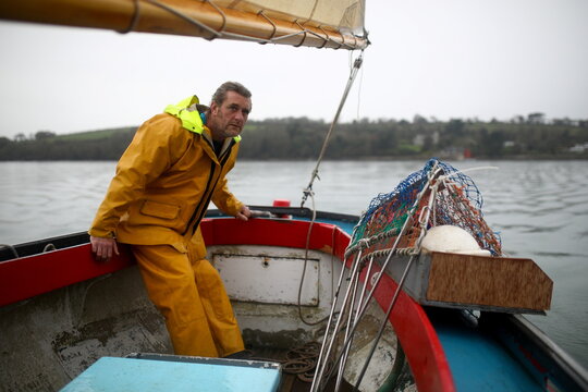 Oyster fisherman Adam Spargo sails on his traditional, sail-powered boat "Mistress" whilst dredging for oysters in the Fal Estuary