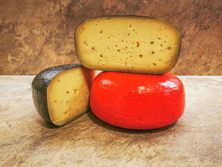 Freshly into two pieces cut wax-coated cheese wheels