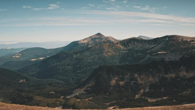Autumn mountain ranges aerial. Nobody nature landscape. Green pine trees forets on hills, peaks. Greenery grass valley. Travel to Carpathians mount ridges , Ukraine, Europe. Cinematic drone shot