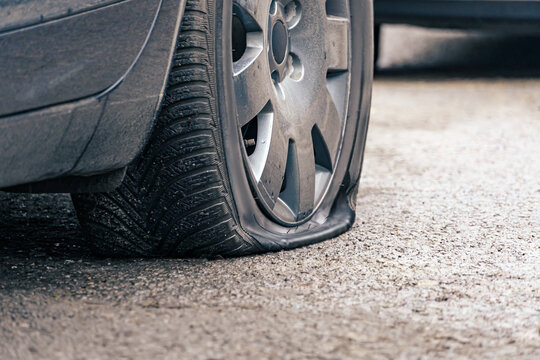 flat car tire close up, punctured wheel