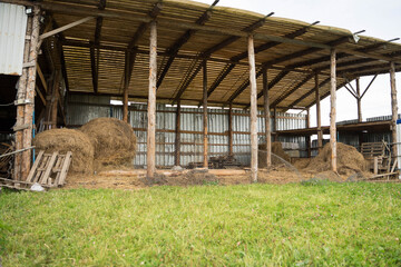 large wooden shed with hay