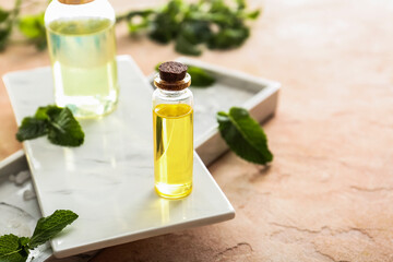Bottles of mint essential oil on table