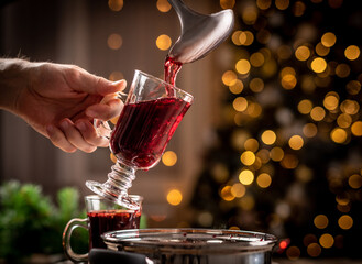 Pouring red mulled wine into glass