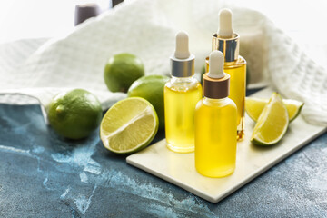 Bottles with citrus essential oil on table