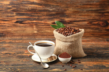 Composition with cup of coffee on wooden background