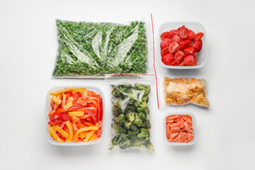 Containers and plastic bags with frozen vegetables on white background