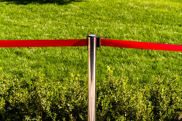 Red Barrier tape, green grass background.