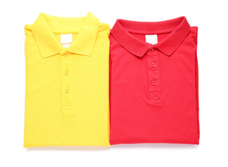 Folded polo shirts on white background