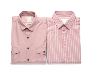 Folded male shirts on white background