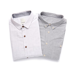 Folded male shirts on white background