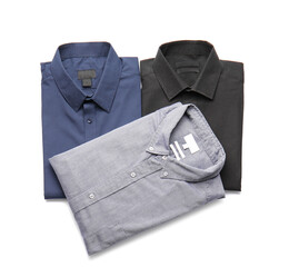 Folded male shirts on white background