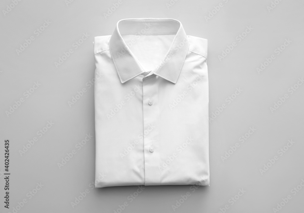 Sticker Folded male shirt on light background