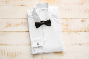 Folded male shirt on wooden background