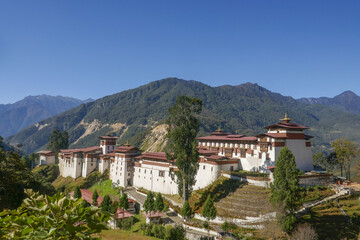 Fototapeta na wymiar Magnificent view of Trongsa dzong in Central Bhutan the religious and administrative headquarters of the province with mountain background