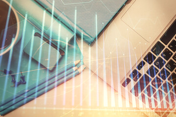 Double exposure of forex graph drawing over desktop background with computer. Concept of financial analysis. Top view.