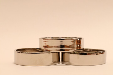 Silver rings in formation.  Shiny metal and design art. Metallic objects. Close up and isolated on a white background. Stockholm, Sweden.