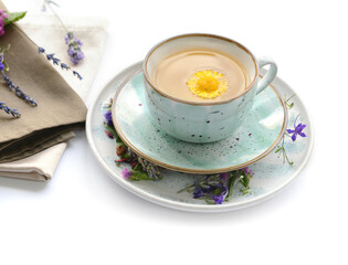Dry flowers and cup of floral tea on white background