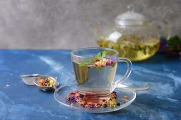 Cup with floral tea on table