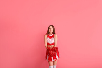 Beautiful young cheerleader on color background