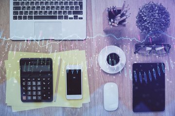 Double exposure of forex chart hologram over desktop with phone. Top view. Mobile trade platform concept.