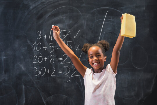 Mixed race elementary school girl happy after getting an A in math