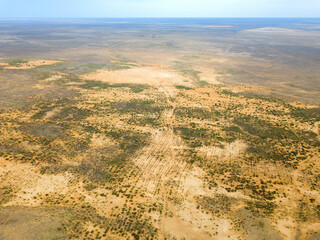 Aerial view on steppe landscape small bushes and other vegetation. Parched salt marsh. Desert dry landscape.
