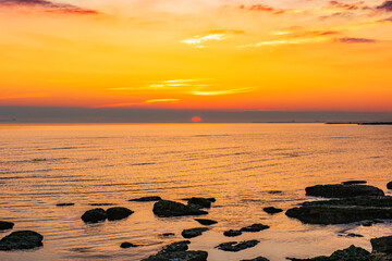 Fototapeta na wymiar Colorful sunrise on the rocky sea coast
