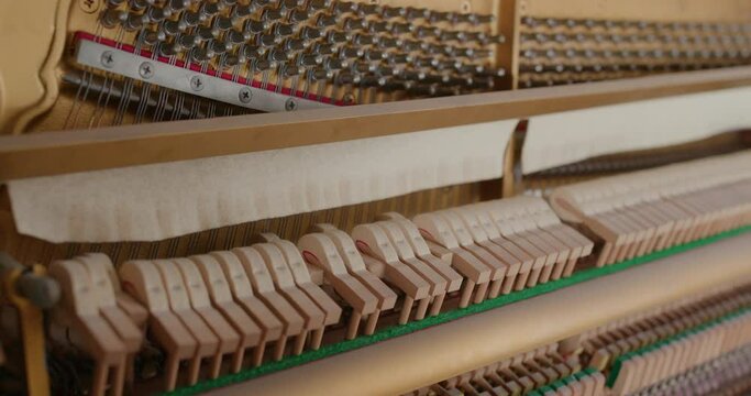 Piano hammers hit the strings