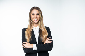 Portrait of young smiling businesswoman standing with hands folded against on white background