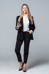 Businesswoman use of the cellphone isolated on gray background