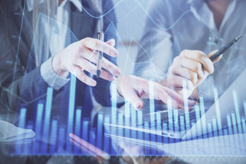 Multi exposure of man and woman working together and financial chart hologram. Business concept. Computer background.