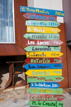 Pole guidepost with multiple european geoparks on arrows sticks in Spanish. Geopark Visitors Reception Center, Caceres, Extremadura, Spain