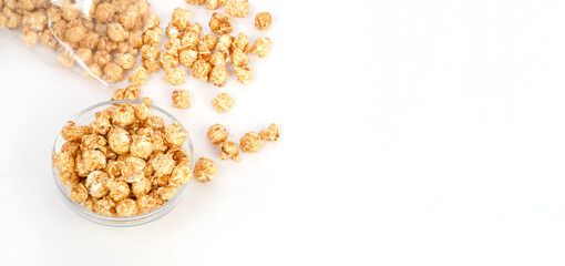Caramel popcorn in a glass bowl with copy space on a white background