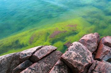 Coast of red granite boulders in the Aland Islands. Finland