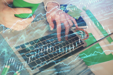 Double exposure of woman hands typing on computer and forex chart hologram drawing. Stock market invest concept.