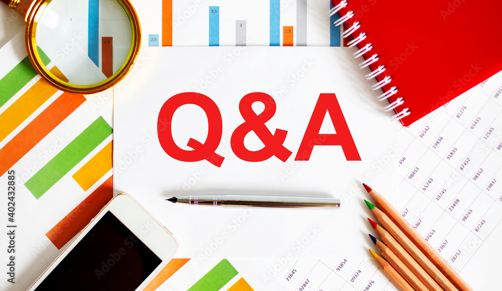 Poster text q and a on the notepad with office tools, pen on financial report