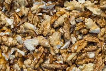 Full frame of peeled raw organic walnuts kernel top view