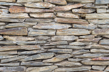A Wall made of an old random size stone. Stone texture for background