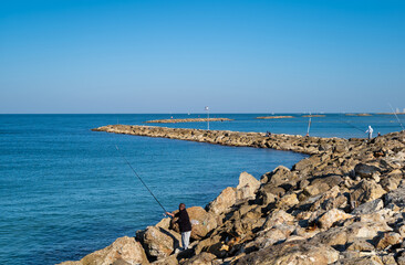 Fishermen on Tel Aviv beach, Israel.