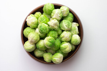 brussels sprouts its leaves lie on the table and in a wooden bowl
