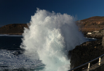 Powerful foamy ocean waves waves are breaking along Las Canteras and El Confital town beaches in Las Palmas de Gran Canaria
