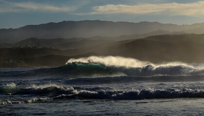 Powerful foamy ocean waves waves are breaking along Las Canteras and El Confital town beaches in Las Palmas de Gran Canaria