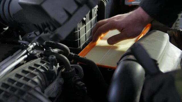 New car air filter new service mechanic hands closeup
