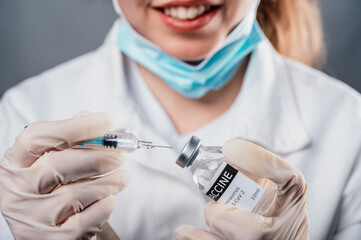 Doctor holding a syringe with a single bottle vial of Covid-19 vaccine for children or adults....