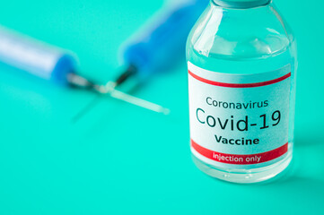 A single bottle vial of Covid-19 vaccine. Medical concept vaccination hypodermic injection...